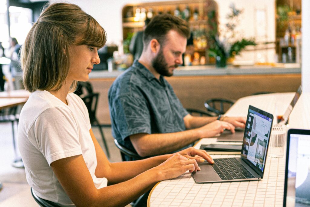 Man and woman working for top 10 freelance platforms for digital marketers